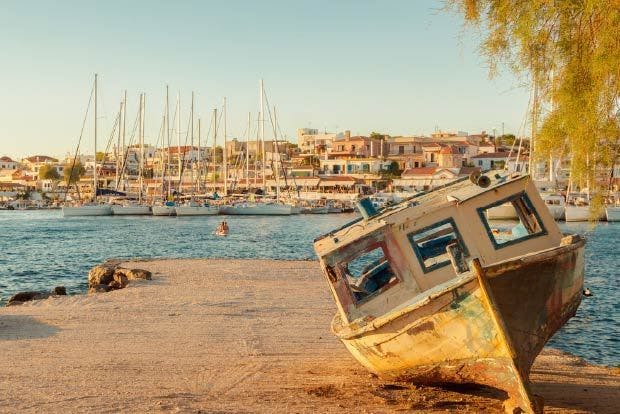 Photo of an old wooden fishing boat at sunset in Perdika in the Greek Saronic